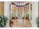 Grand lobby featuring soaring ceilings, elegant columns, and inviting seating by the door at 2442 Silvermoss Dr, Wesley Chapel, FL 33544