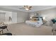 Bright main bedroom with a decorative ceiling, large windows, stylish furniture, and elegant decor at 2442 Silvermoss Dr, Wesley Chapel, FL 33544
