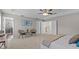 Bright main bedroom with a decorative ceiling, large windows, stylish furniture, and elegant decor at 2442 Silvermoss Dr, Wesley Chapel, FL 33544