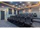 A beautiful tiered theater room features comfortable seating, lighting and a large screen at 2442 Silvermoss Dr, Wesley Chapel, FL 33544
