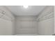 Walk-in closet with metal racks, shelving, and ample space for organized storage at 2442 Silvermoss Dr, Wesley Chapel, FL 33544