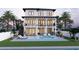 Exterior of a two-story home, featuring a swimming pool, lounge chairs, a grill and outdoor dining space at 2519 N Riverside Dr, Tampa, FL 33602