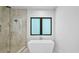 Modern bathroom with soaking tub and tiled walk-in shower at 2519 N Riverside Dr, Tampa, FL 33602
