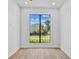 Bright bedroom with hardwood floors, a large window, and views of the lawn and trees at 2519 N Riverside Dr, Tampa, FL 33602