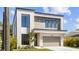 Modern exterior with neutral tones, stylish windows, a two-car garage, and well-maintained landscaping at 2519 N Riverside Dr, Tampa, FL 33602
