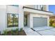 Modern home featuring an attached garage, sleek address numbers, and manicured landscaping at 2519 N Riverside Dr, Tampa, FL 33602