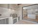 A modern outdoor kitchen features a built-in grill, stainless steel appliances, and a marble countertop at 2519 N Riverside Dr, Tampa, FL 33602