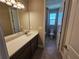 Bright bathroom features a granite countertop, undermount sink and tiled floors at 2595 Wise River Ln, Zephyrhills, FL 33541