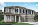 Charming two-story home with a two-car garage and lovely front yard landscaping at 2595 Wise River Ln, Zephyrhills, FL 33541