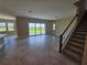 Expansive living room filled with natural light, featuring tile flooring and sliding glass doors to outdoors at 2595 Wise River Ln, Zephyrhills, FL 33541