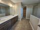 Main bathroom featuring double vanity, and a glass-enclosed shower, blending style with functionality at 2595 Wise River Ln, Zephyrhills, FL 33541
