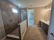 Modern main bathroom features a luxurious glass shower and double vanity with sleek fixtures at 2595 Wise River Ln, Zephyrhills, FL 33541