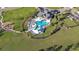 Community pool and amenities aerial view with a clubhouse, playground, and dog park nearby at 30226 Merilee Pl, Wesley Chapel, FL 33545