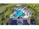Overhead shot of community pool featuring a water slide, lounge chairs, and tropical landscaping at 30226 Merilee Pl, Wesley Chapel, FL 33545