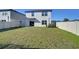 Spacious backyard with green lawn, ideal for outdoor activities and enjoying the natural surroundings at 30226 Merilee Pl, Wesley Chapel, FL 33545