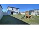 Large, grassy backyard featuring a wooden playset, perfect for and outdoor fun with Gathering and friends at 30226 Merilee Pl, Wesley Chapel, FL 33545