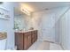 Bathroom featuring a double sink vanity, modern lighting, and a shower/tub combo with clean white tile at 30226 Merilee Pl, Wesley Chapel, FL 33545