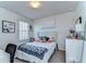 Cozy bedroom featuring plush bed and soft decor, illuminated by natural light at 30226 Merilee Pl, Wesley Chapel, FL 33545