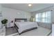 Bright bedroom with plush carpet, a comfortable bed, and sunlit windows with sheer curtains at 30226 Merilee Pl, Wesley Chapel, FL 33545
