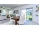 Bright dining room with backyard access, a round table, and views of the backyard play set at 30226 Merilee Pl, Wesley Chapel, FL 33545
