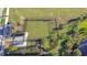 Aerial view of a fenced dog park in a community featuring green space and trees at 30226 Merilee Pl, Wesley Chapel, FL 33545