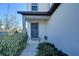 Charming front entryway featuring a stylish door with a decorative wreath and manicured landscaping at 30226 Merilee Pl, Wesley Chapel, FL 33545