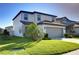 This charming home features manicured landscaping and a spacious driveway leading to an attached two-car garage at 30226 Merilee Pl, Wesley Chapel, FL 33545
