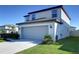 Two-story home with a spacious two-car garage, concrete driveway and a neatly landscaped yard at 30226 Merilee Pl, Wesley Chapel, FL 33545