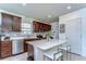 The modern kitchen showcases an island with seating, stainless steel appliances, and stylish finishes at 30226 Merilee Pl, Wesley Chapel, FL 33545
