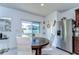 Bright kitchen nook with a wood dining table and stainless steel refrigerator, perfect for cozy meals at 30226 Merilee Pl, Wesley Chapel, FL 33545