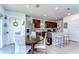 Open kitchen with stainless steel appliances, dark wood cabinets, breakfast bar, and a cozy dining area at 30226 Merilee Pl, Wesley Chapel, FL 33545