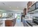 Bright, modern kitchen with a center island, stainless steel appliances, and an open layout at 30226 Merilee Pl, Wesley Chapel, FL 33545