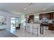 Bright eat-in kitchen featuring stainless steel appliances, a white island, and access to the backyard at 30226 Merilee Pl, Wesley Chapel, FL 33545