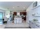 Well-lit kitchen features stainless steel appliances, island with seating, and sleek countertops at 30226 Merilee Pl, Wesley Chapel, FL 33545