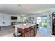 Open concept kitchen and living space with an island and plenty of natural light at 30226 Merilee Pl, Wesley Chapel, FL 33545