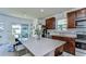 Modern kitchen features stainless steel appliances, a center island, and backyard view from breakfast nook at 30226 Merilee Pl, Wesley Chapel, FL 33545