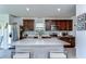 Modern kitchen with stainless steel appliances, a large island, and dark wood cabinetry at 30226 Merilee Pl, Wesley Chapel, FL 33545