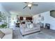 Spacious living room flows into the dining area and modern kitchen, perfect for entertaining at 30226 Merilee Pl, Wesley Chapel, FL 33545