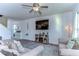 Comfortable living room boasts a ceiling fan, television, modern decor, and neutral color palette at 30226 Merilee Pl, Wesley Chapel, FL 33545