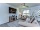 Comfortable living room featuring stylish decor, a large TV, and a ceiling fan at 30226 Merilee Pl, Wesley Chapel, FL 33545