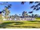 Relaxing community pool area with plenty of lounge chairs, umbrellas, and palm trees, ideal for summertime fun at 30226 Merilee Pl, Wesley Chapel, FL 33545