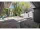 Backyard featuring a crushed rock patio, a turquoise Adirondack chair, and a privacy fence at 311 W Fern St, Tampa, FL 33604