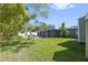 Expansive grassy backyard featuring a screened in lanai at 311 W Fern St, Tampa, FL 33604