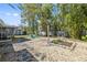 Landscaped backyard featuring a pea gravel lounge area, outdoor shower, garden and screened in lanai at 311 W Fern St, Tampa, FL 33604
