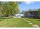 Well-maintained backyard featuring a pea gravel lounge area with two chairs at 311 W Fern St, Tampa, FL 33604