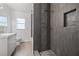 Updated bathroom featuring gray tile in the shower, designer accents, and a bright white vanity at 311 W Fern St, Tampa, FL 33604
