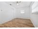 Bright bedroom with hardwood floors, white walls, ceiling fan, plus two windows and a closet at 311 W Fern St, Tampa, FL 33604