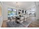 Bright dining area featuring modern light fixture and direct access to an updated kitchen at 311 W Fern St, Tampa, FL 33604