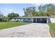 Charming single-story home featuring a spacious carport, lush lawn and inviting curb appeal at 311 W Fern St, Tampa, FL 33604
