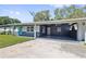Charming single-story home featuring a spacious carport and lush lawn with curb appeal at 311 W Fern St, Tampa, FL 33604